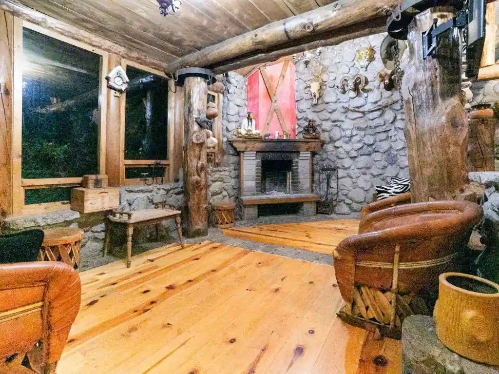 Rustic stone lounge with fireplace